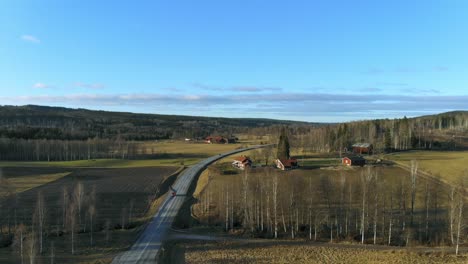 drone shot over country road in sweden in winter without snow