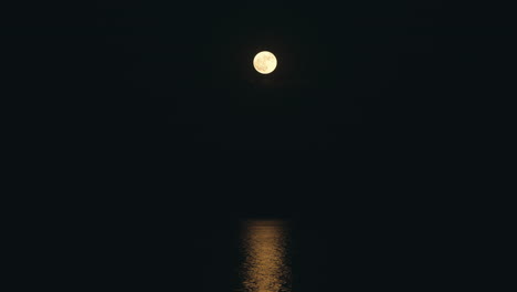 time lapse of a full moon reflection mirrored on ocean water