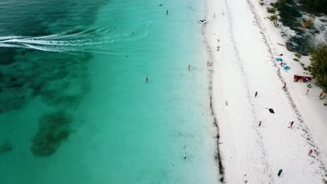 amacing slowly sinking down fly forwards drone shot over jet sky beach