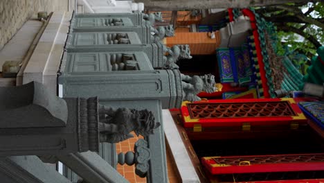 ornate stone railing with lion statues at wong tai sin temple, hong kong