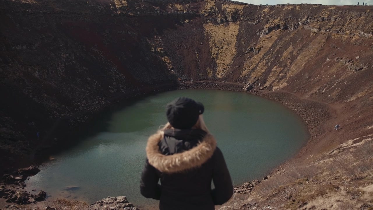 Woman Looking at Kerid Volcanic Crater Lake in Iceland