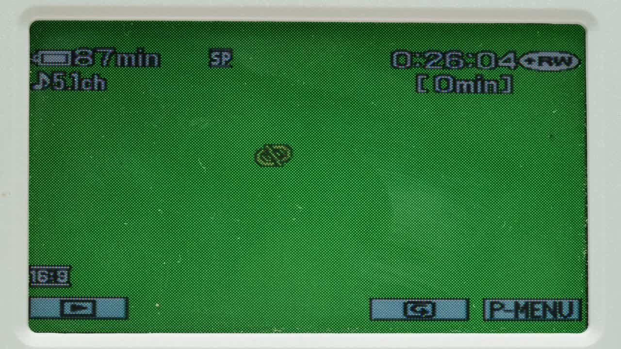 Old vintage video camera close-up. Popular retro camcorder shooting. Chroma key green screen on video-camera monitor.