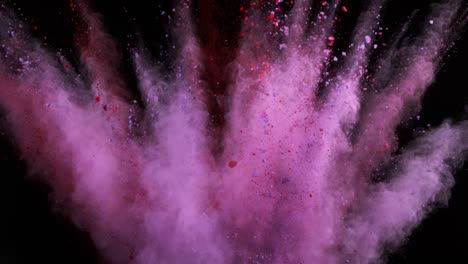 super slow motion of colored powder explosion isolated on dark background.