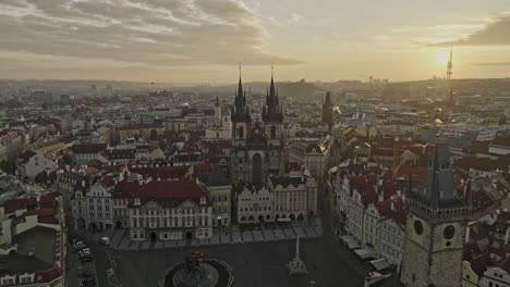 prague czechia aerial v133 flyover old town square, dramatic fly in between gothic spires of church of our lady before tyn capturing golden sunrise cityscape - shot with mavic 3 cine - november 2022