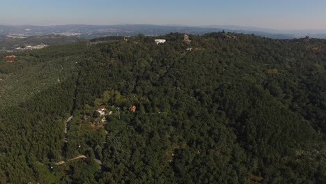 Flying-Over-Church-in-the-Mountain-with-Green-Forest