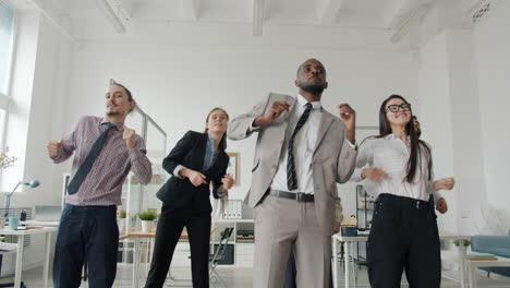 happy business team dancing in office