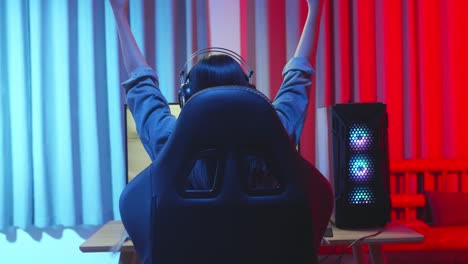 young asian girl gamer win in racing video game