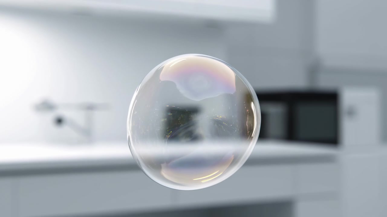 A clear soap bubble hovers near the center of a bright, softly blurred interior, with gentle reflections, smooth surface details, and diffuse daylight