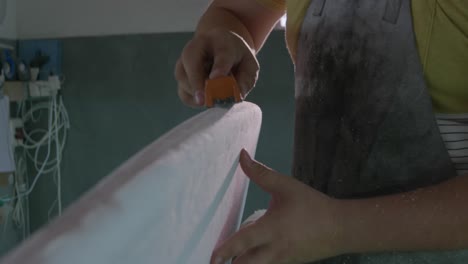 male surfboard maker in his workshop