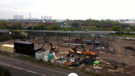 aerial view of aldi grocery store building site foundation steel framework and construction equipment under power station skyline