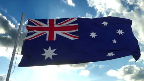 the national flag of australia blowing in the wind against a blue sky