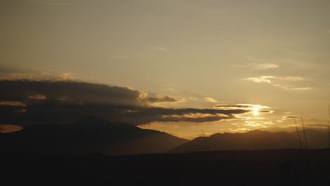 sunset time lapse of the rocky mountain silhouette, while clouds roll past in the summer. alberta canada