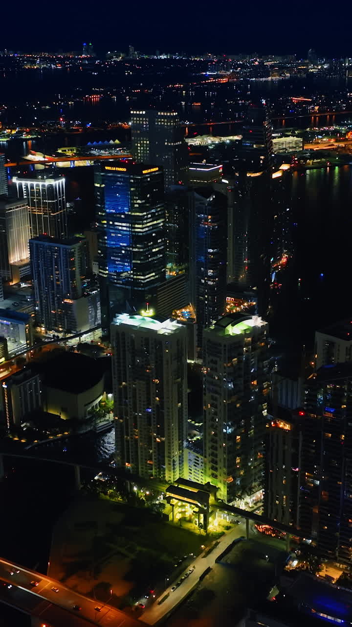 Splendid view of Miami, Florida with numerous lights on. Scenery of night metropolis from top. Vertical video