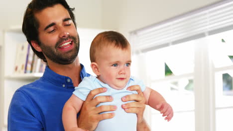 Happy-father-playing-with-his-baby