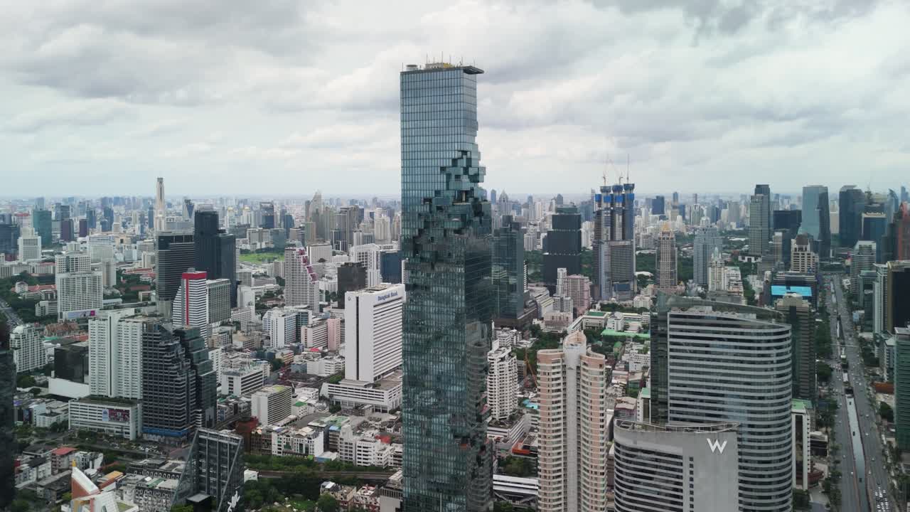 Aerial Drone View of Bangkok City Skyline Featuring Iconic Mahanakhon Tower and Expanding Urban Landscape