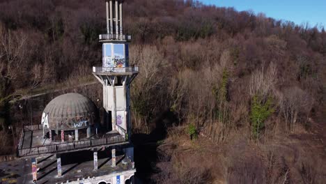 aerial flying over the minaret at abandoned ghost town consonno