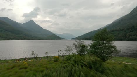 Low-drone-shot-over-small-island-in-Scottish-Loch-leven