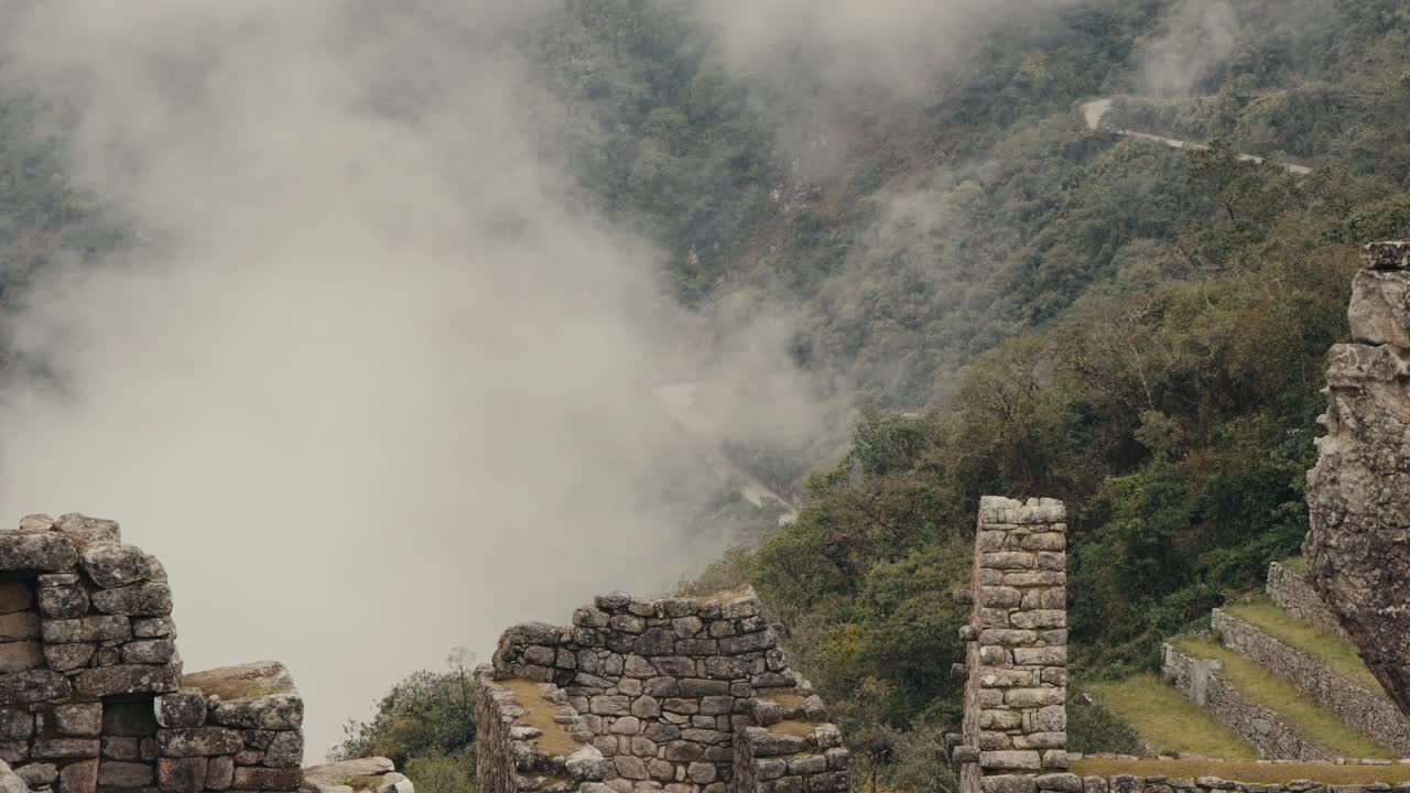 The Misty Ruins of Machu Picchu Overlook the Lush Landscape in the Peruvian Andes, Peru - Static Shot