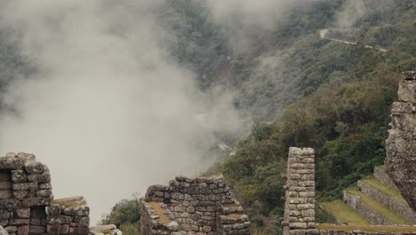 the misty ruins of machu picchu overlook the lush landscape in the peruvian andes, peru - static shot