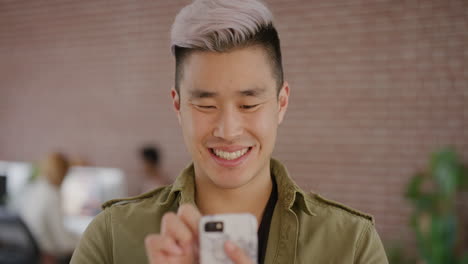 portrait stylish young asian man using smartphone texting browsing online messages on mobile phone app enjoying digital communication smiling satisfaction