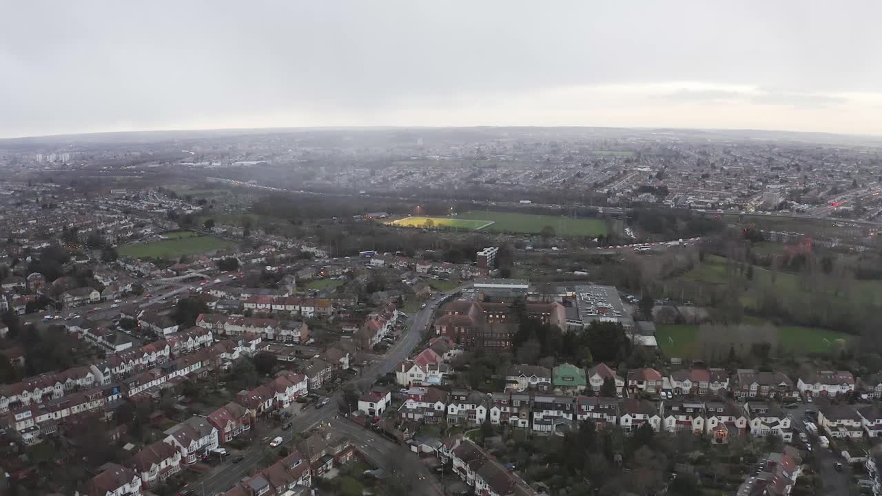 Wanstead, London aerial view over sports field with misty London in distance.