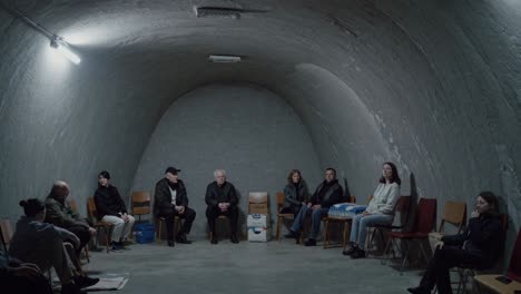 displaced civilians huddling in dimly lit underground shelter, seeking protection from aerial attacks, displaying profound emotional distress and collective vulnerability