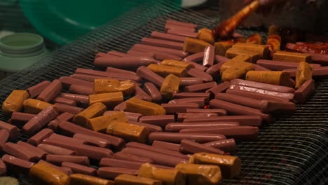 View-of-people-marinating-sausages-on-BBQ-Grill