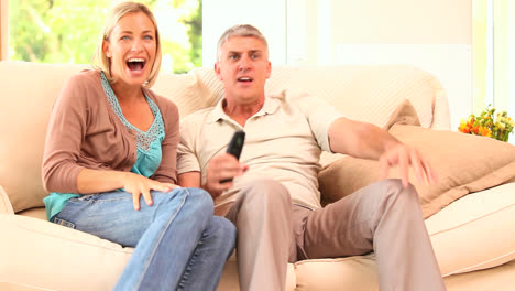 couple watching thrilling event on tv