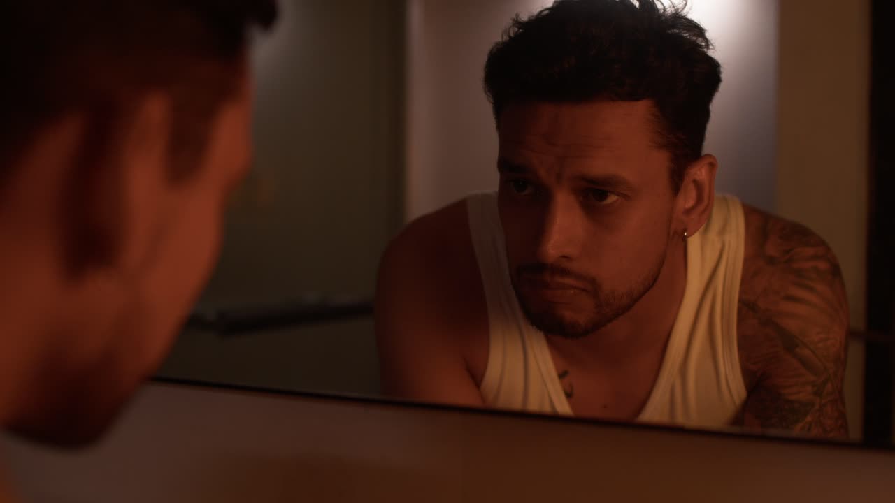 Man looking at himself in the mirror