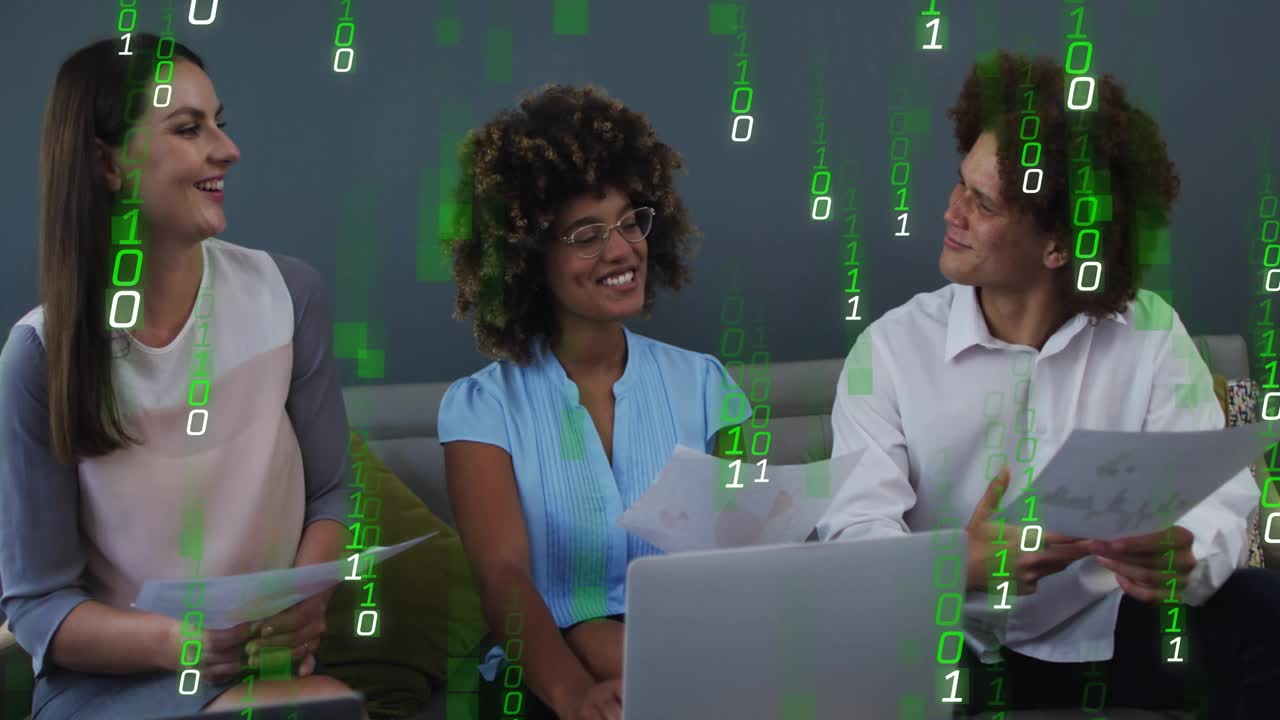 Team reviewing business docs on sofa, center lead pointing at laptop causing green binary overlay