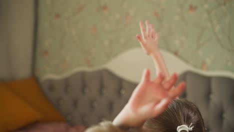 Boy-and-girl-raise-hands-to-answer-question-sitting-at-desk