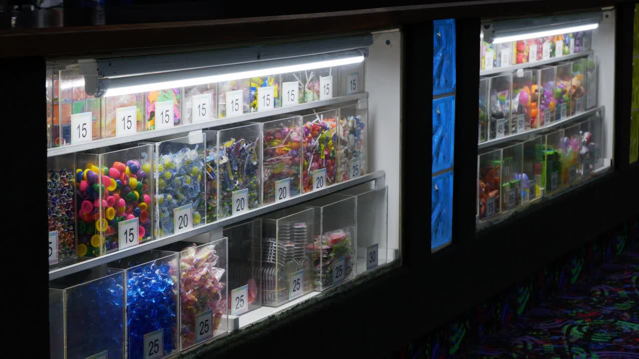 Children’s kids play center ticket redemption booth with cheap plastic prizes for arcade family fun center games from token play - in Cinema 4k (30fps slowed from 60fps).