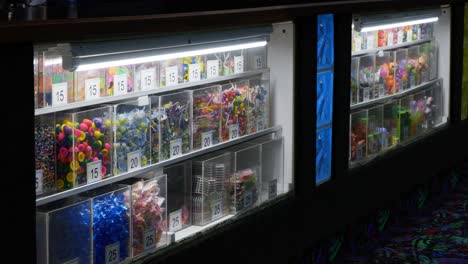 children’s kids play center ticket redemption booth with cheap plastic prizes for arcade family fun center games from token play - in cinema 4k (30fps slowed from 60fps).