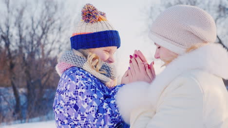 Mom-And-Daughter-Warm-The-Palms-Of-Their-Hands