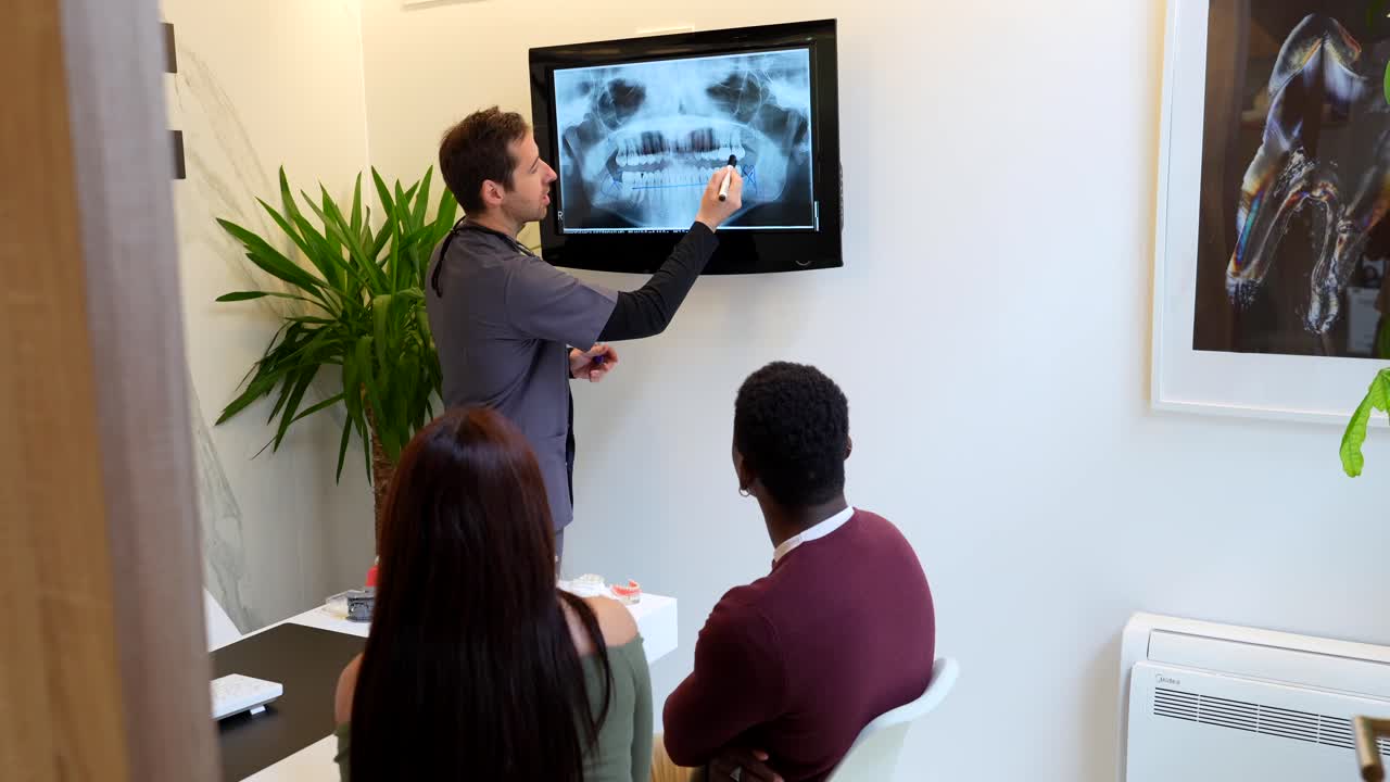 Dentist explaining X-ray to patients