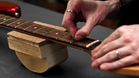 putting new guitar string through the tuning machine post