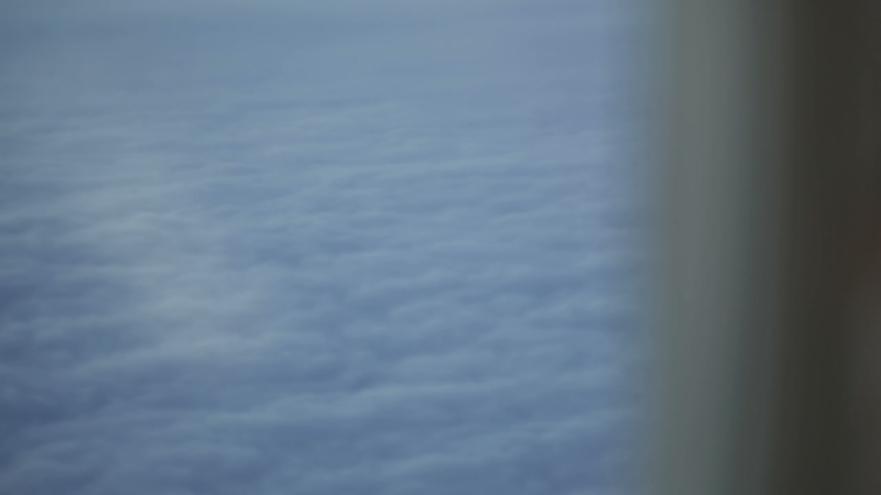 Woman looking at the clouds during flight