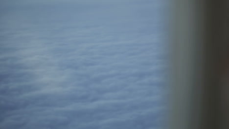 Woman-looking-at-the-clouds-during-flight