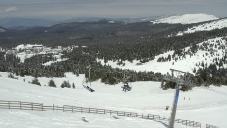 winter mountain ski resort with chairlifts and skiers