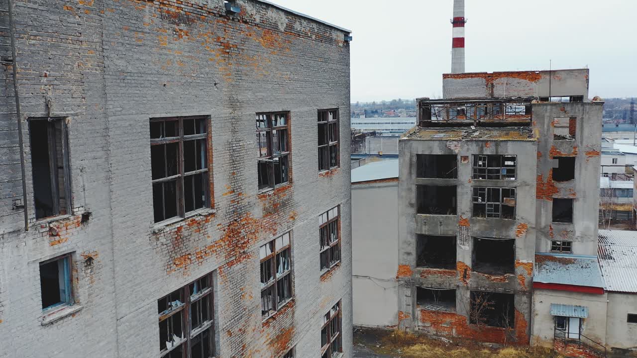 Ruined old brick buildings with broken windows and doors. Industrial park. Aerial view