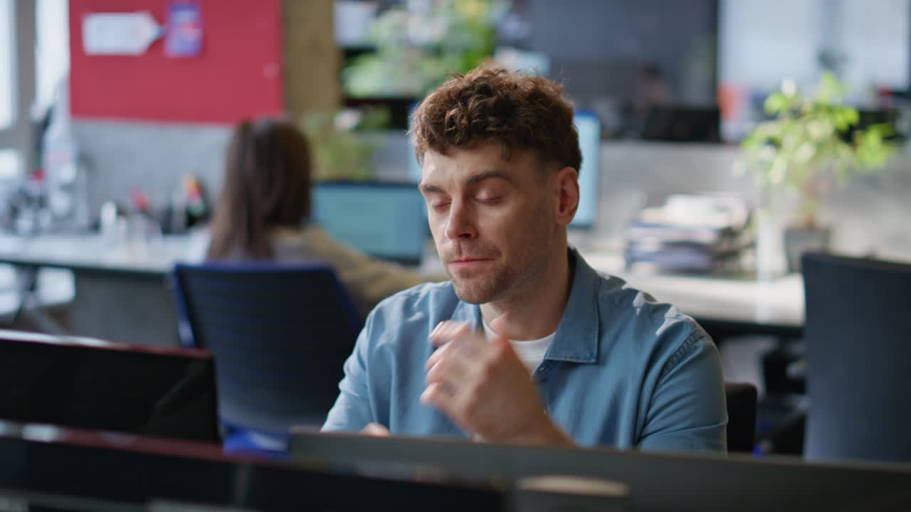 Office manager feeling tired looking computer at corporate workplace closeup