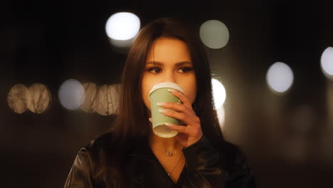 Cinematic-Bokeh-Portrait-Shot-of-Pretty-Elegant-Brunette-Woman,-Thoughtful-Drinking-Coffee-By-Night