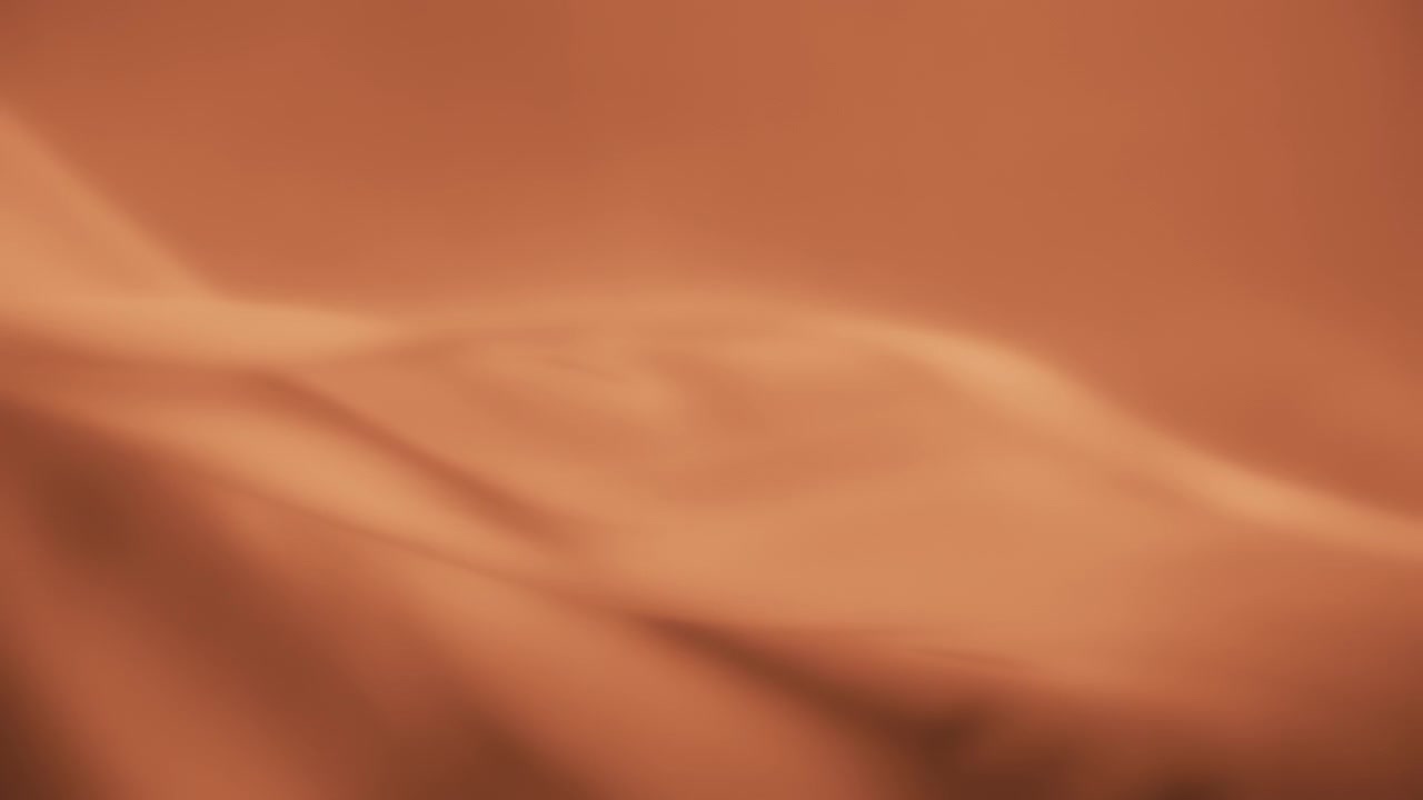 Fondo de textura de tela de gasa naranja ondeando al viento.
