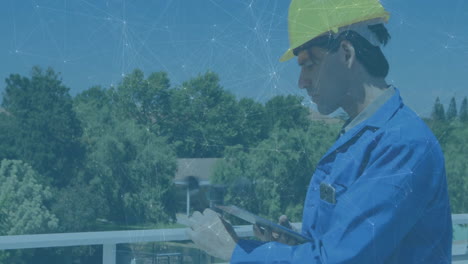 construction worker analyzing smart tablet data on platform, showing animated schematics and charts