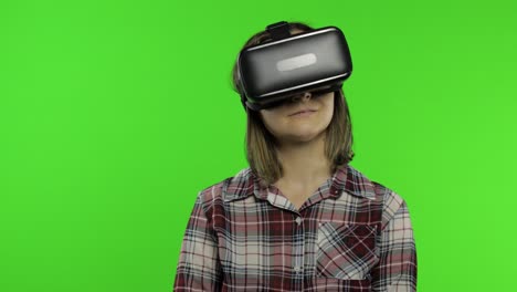 Woman-using-VR-headset-helmet-to-play-game,-dance.-Watching-virtual-reality-3d-video.-Chroma-key