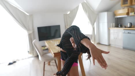 woman stretching and dancing at home