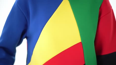 vibrant colorful apparel showcasing a unique design with bold panels in blue, yellow, green, and red against a minimal white background