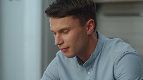 guy watching internet video closeup sitting at home. man looking social networks