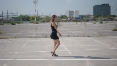 young woman walking in urban parking lot