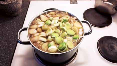 hot and tasty soup simmering on the stove - cooking pork cabbage soup